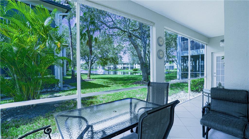 300 Diamond Circle, Unit 301 Naples, FL 34110 - Photo 8 of 43 a view of a patio with a table chairs and a backyard