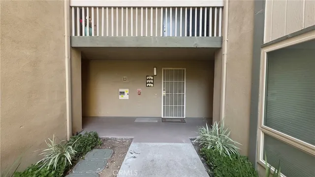 a view of a house with potted plants