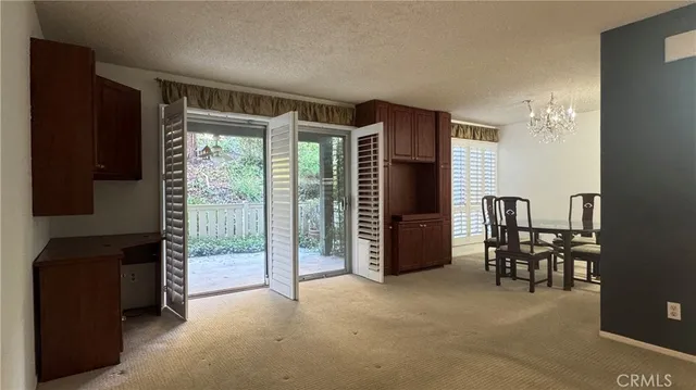 a view of a room with furniture and a window