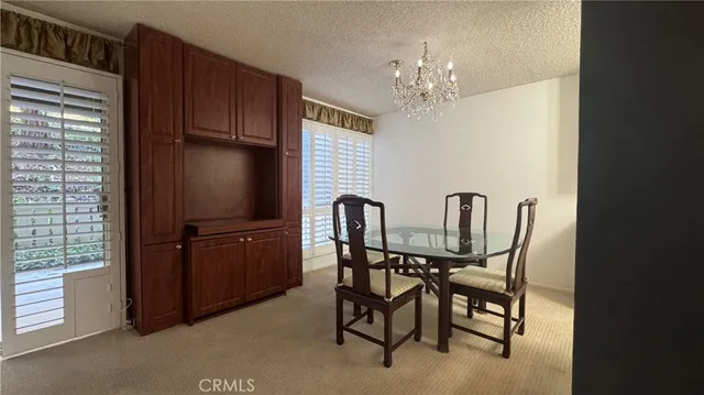 a dining room with furniture and chandelier