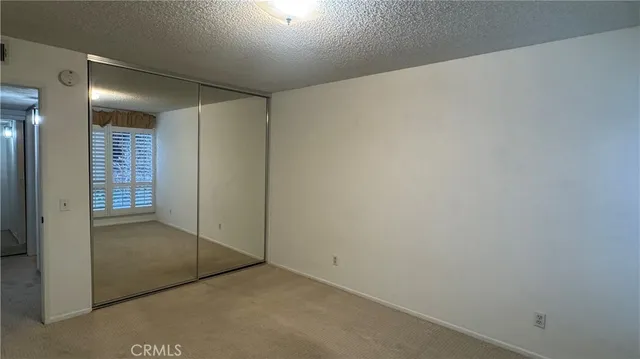 an empty room with mirror in it