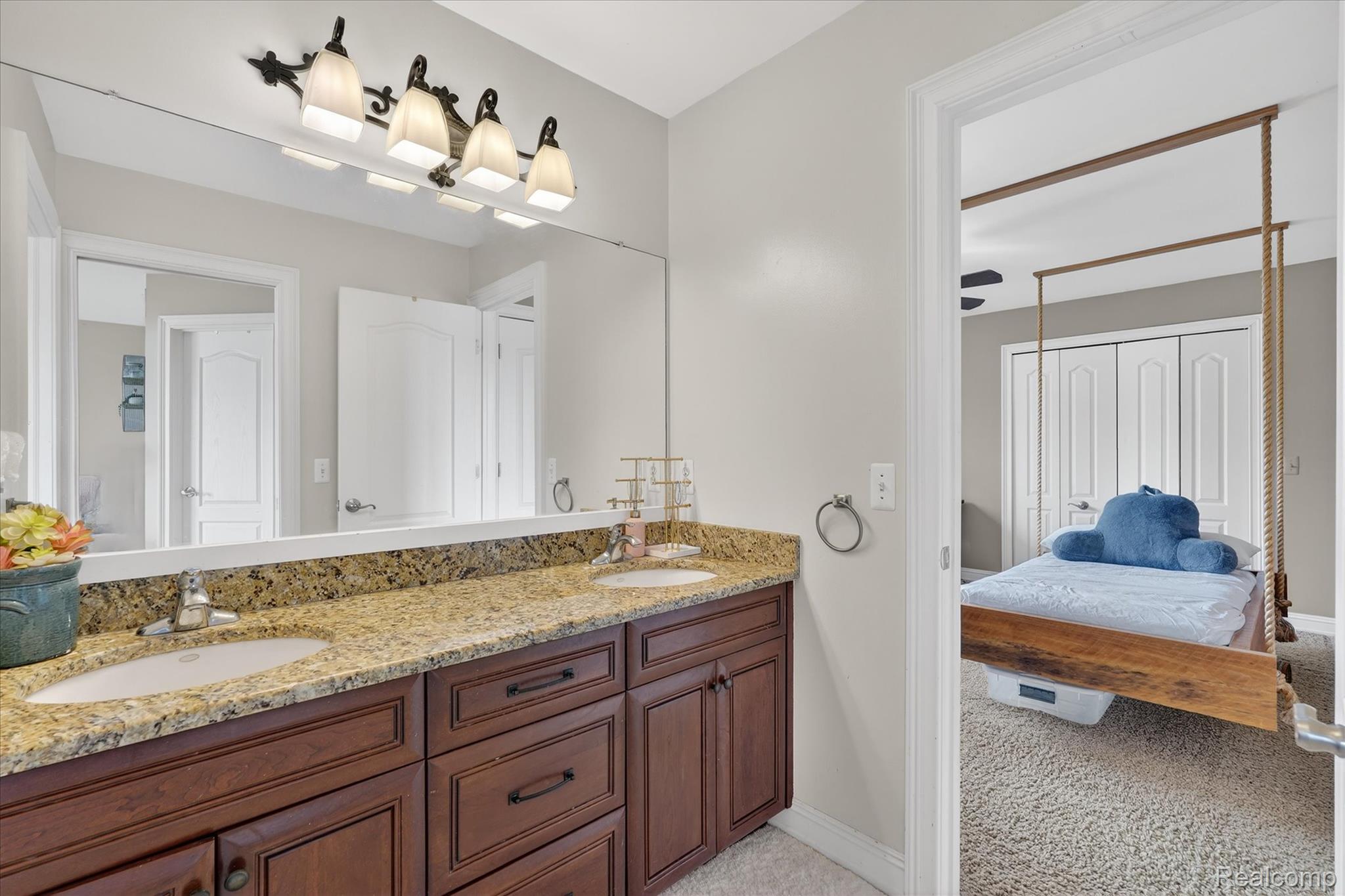 6932 Oakhurst Ridge Road Clarkston, MI 48348 - Photo 41 of 78 Ensuite bathroom featuring double vanity and light colored carpet