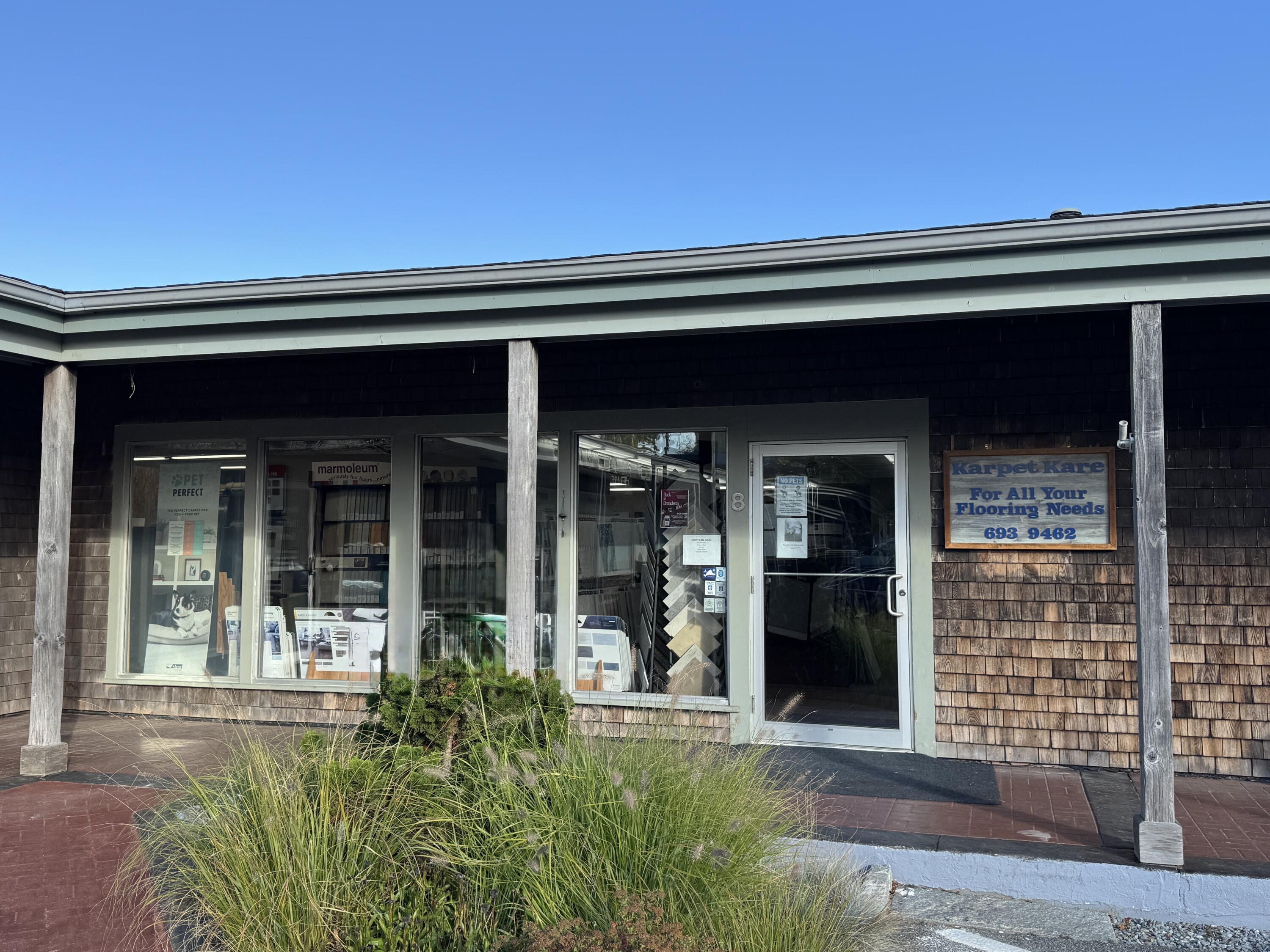 front view of a house with potted plants