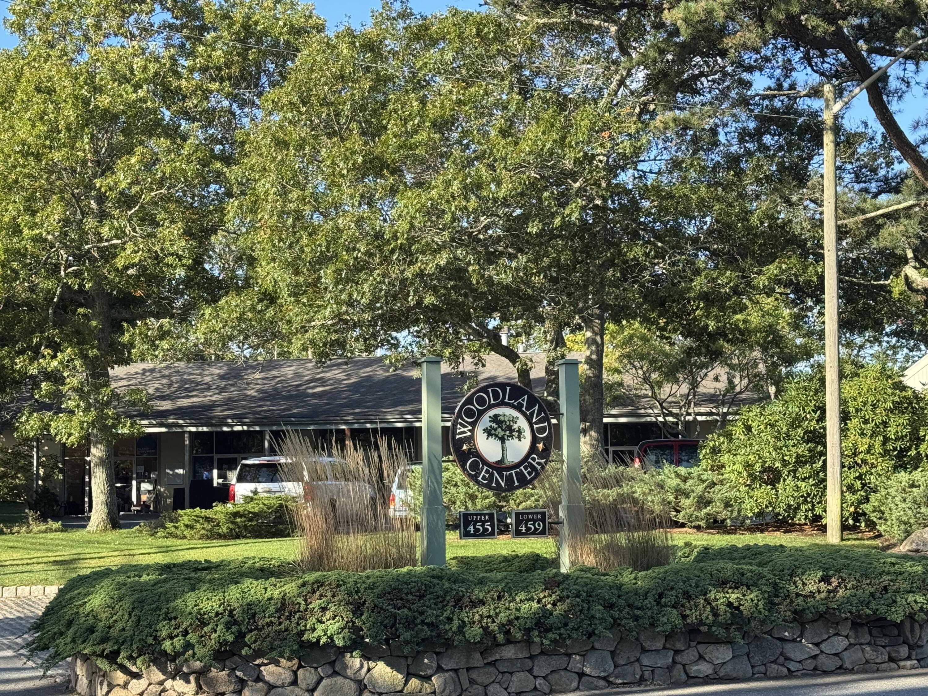 455 State Road, Unit 8 Vineyard Haven, MA 02568 - Photo 2 of 12 a view of a big house with large trees and plants