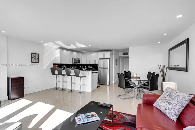 a living room with furniture and kitchen view