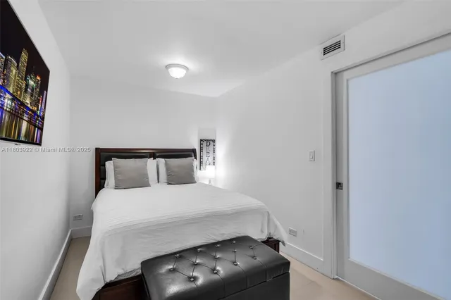 a bedroom with a bed and a tv