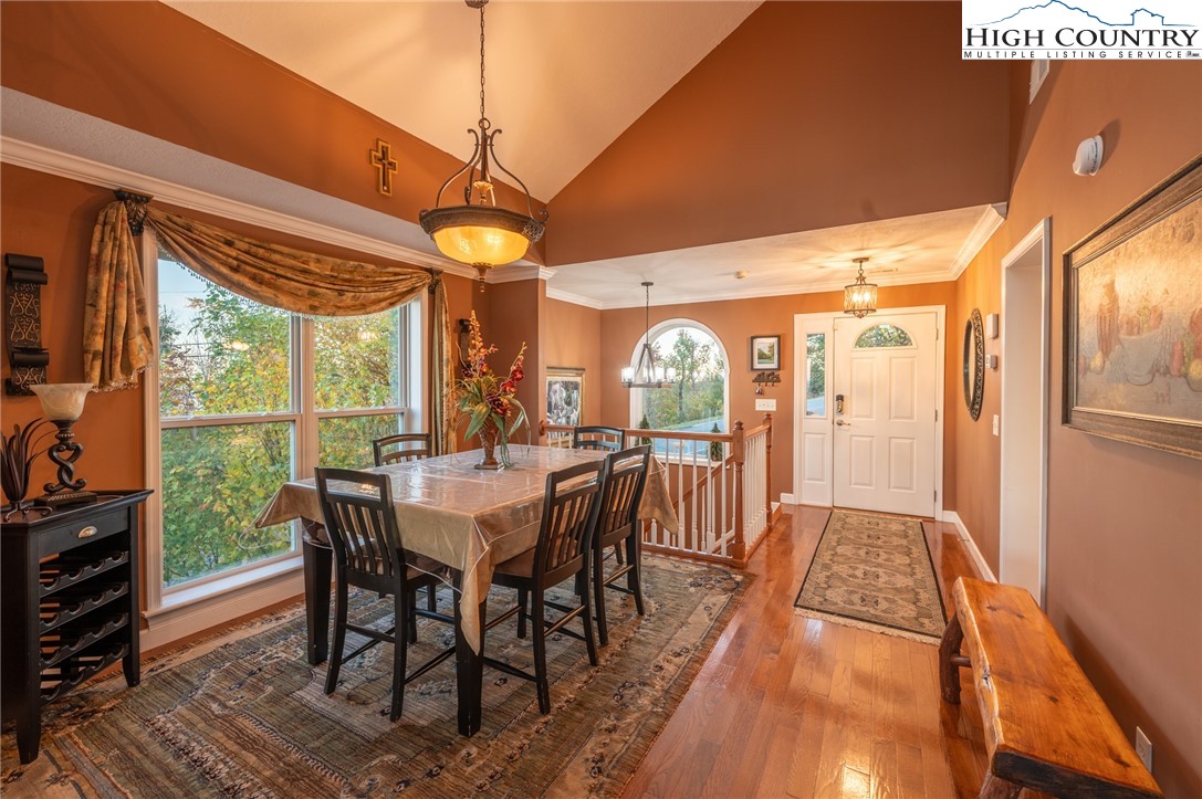 309 Pinnacle Ridge Road Beech Mountain, NC 28604 - Photo 11 of 45 a dining room with furniture a chandelier and wooden floor