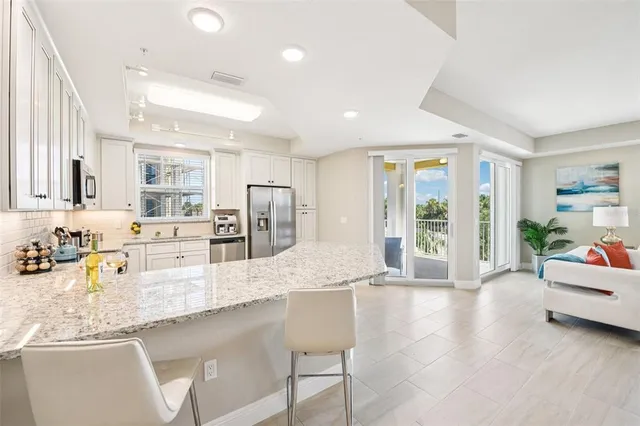 a large white kitchen with a large window