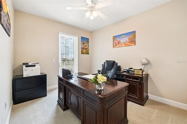 a view of a workspace with furniture and a window