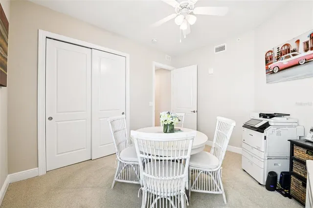 a bedroom with a large bed and a flat tv screen on dresser
