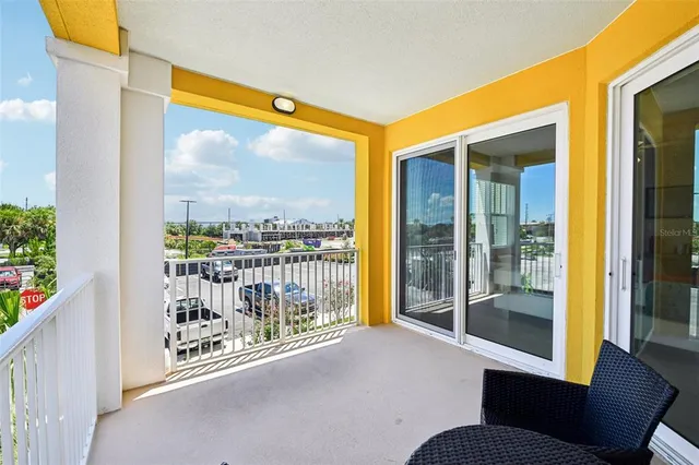 a dining room with stainless steel appliances kitchen island granite countertop a table chairs and a refrigerator