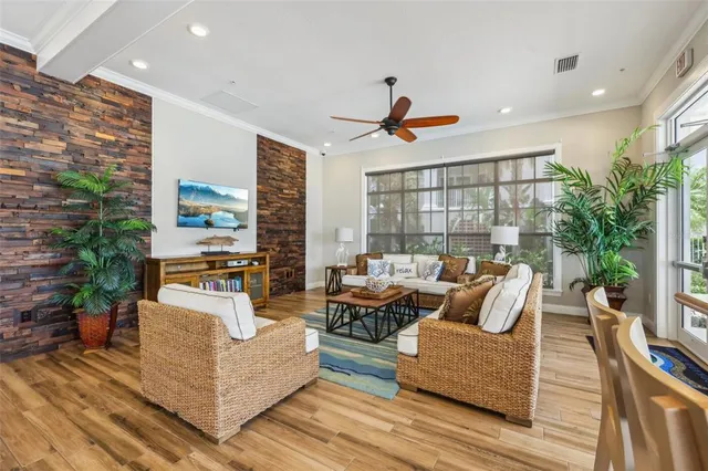 a living room with furniture and a potted plant
