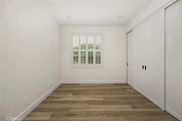 a view of a room with wooden floor and window