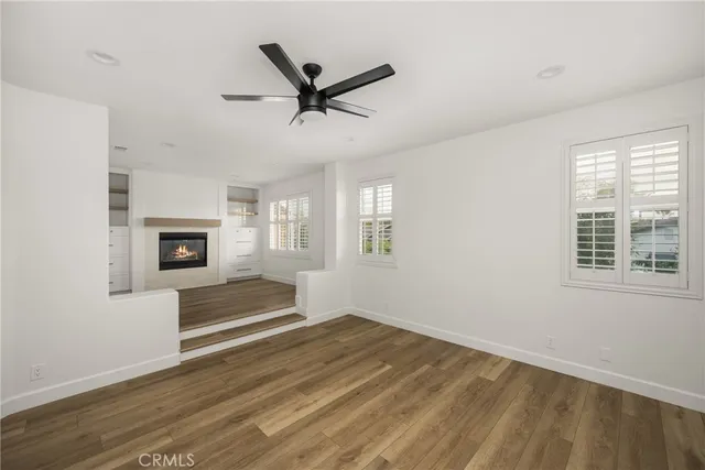 a view of a livingroom with a ceiling fan and window