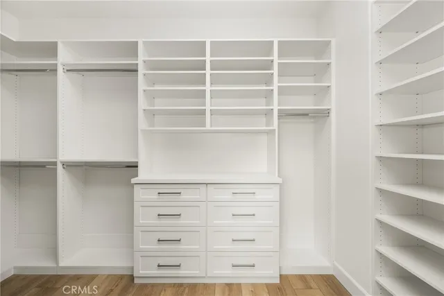 a view of walk in closet with empty racks