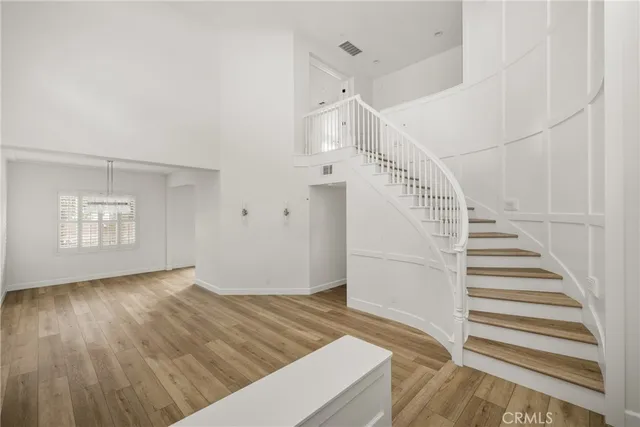 a view of entryway and hall with wooden floor