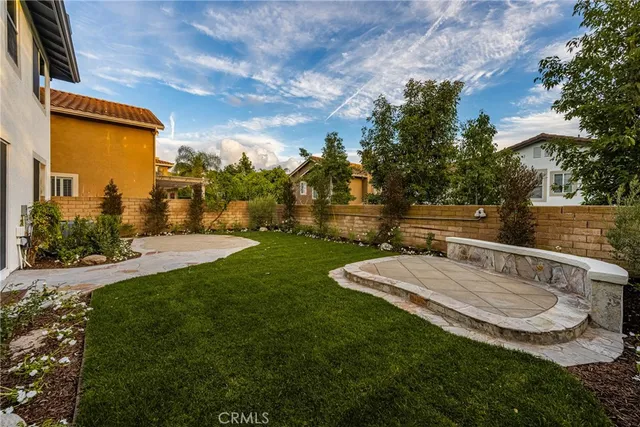 a view of a small house with a backyard