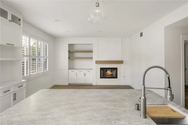 a view of empty room with a fireplace and window
