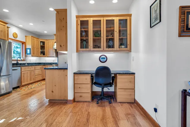 a kitchen with stainless steel appliances granite countertop a stove a sink and a refrigerator