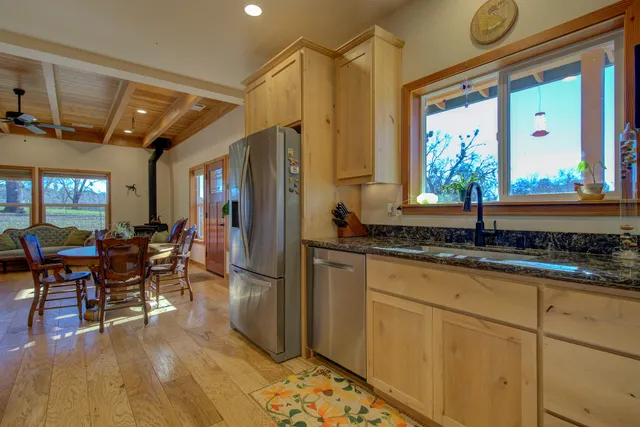 a bathroom with a granite countertop sink a toilet and shower