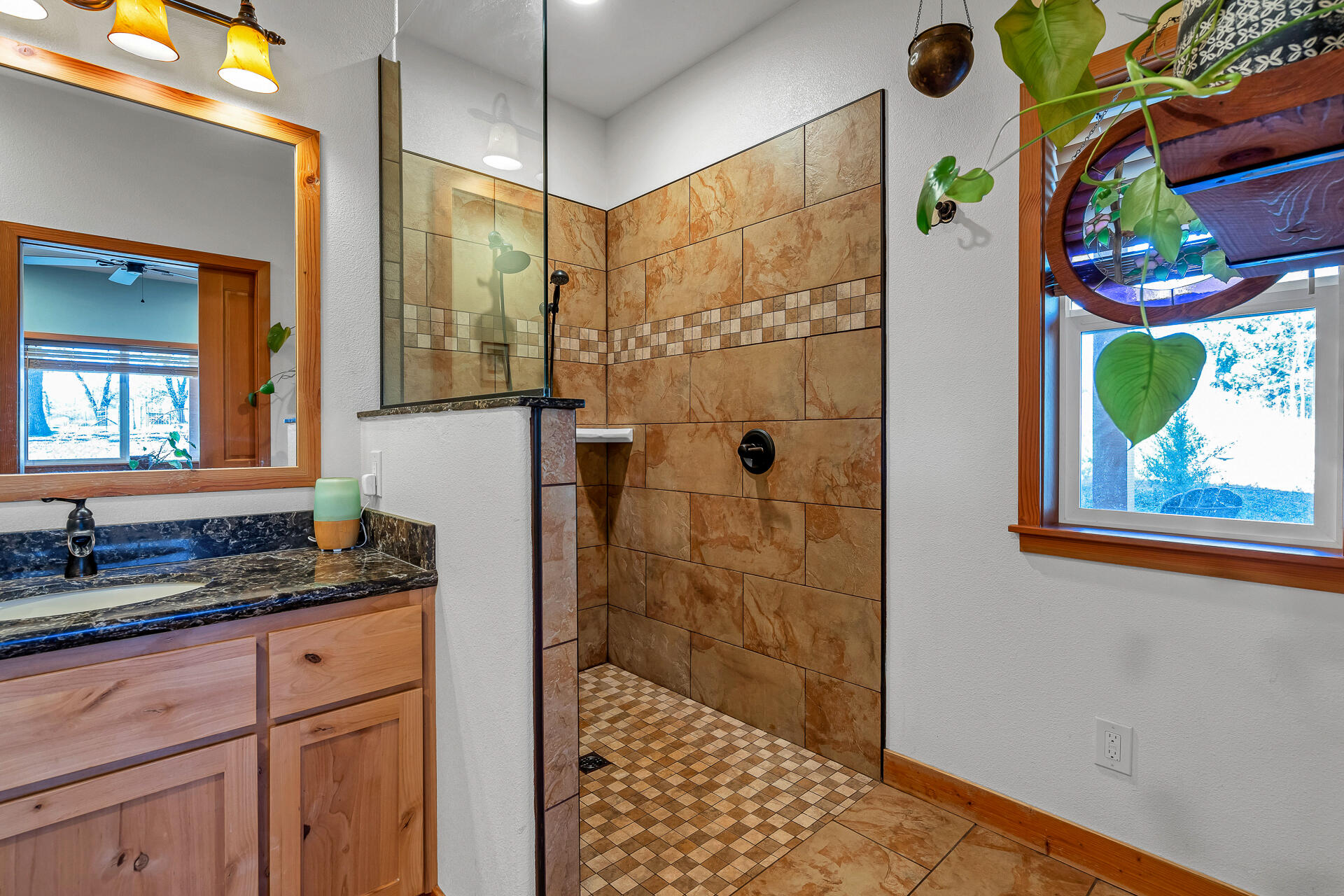 13575 English Way Oak Run, CA 96069 - Photo 25 of 56 a bathroom with a granite countertop sink a shower and a mirror