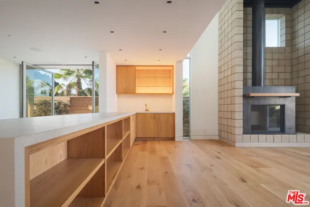 a view of a kitchen with wooden floor and a window