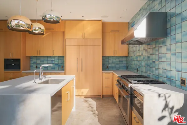 a kitchen that has a sink and a stove