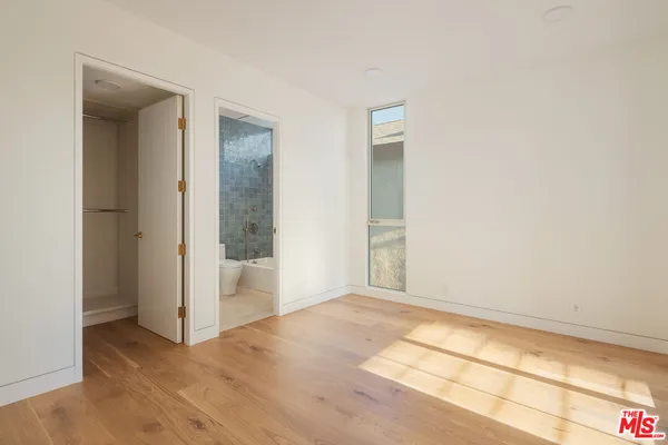a view of wooden floor and windows in a room