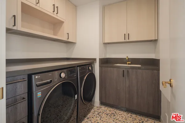 a bedroom with a large bed and a potted plant