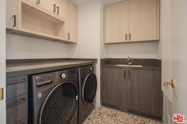 a bedroom with a large bed and a potted plant