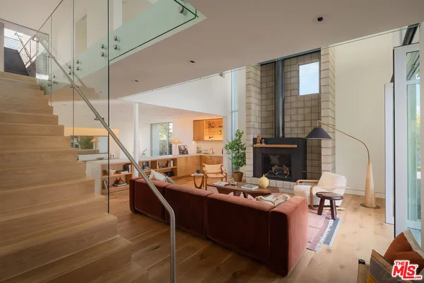 a living room with fireplace furniture and a fireplace