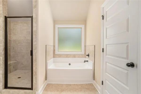 a bathroom with a bathtub and shower