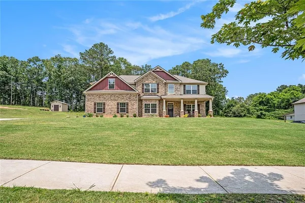 a front view of a house with a garden
