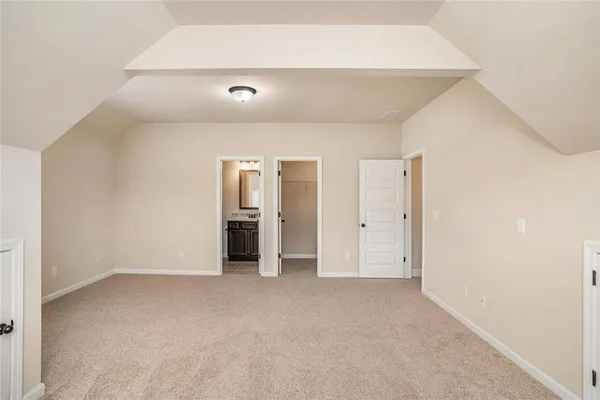 an empty room with closet and a window