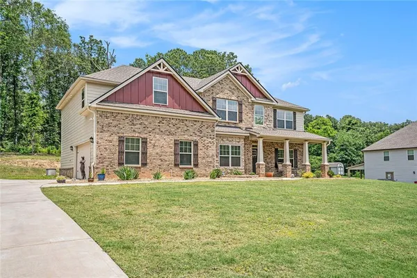 a front view of a house with a yard