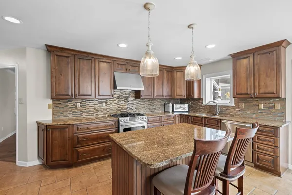 a kitchen with a stove sink and microwave