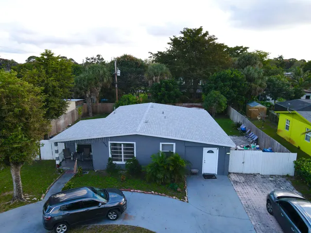 a aerial view of a house next to a yard