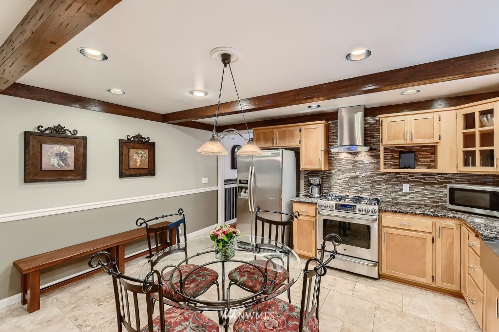 32219 22nd Avenue Southwest Federal Way, WA 98023 - Photo 13 of 36 a kitchen with stainless steel appliances kitchen island granite countertop a sink and cabinets