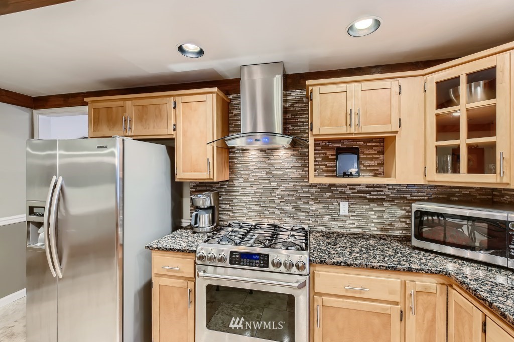 32219 22nd Avenue Southwest Federal Way, WA 98023 - Photo 15 of 36 a kitchen with stainless steel appliances granite countertop a stove a refrigerator and a granite counter tops