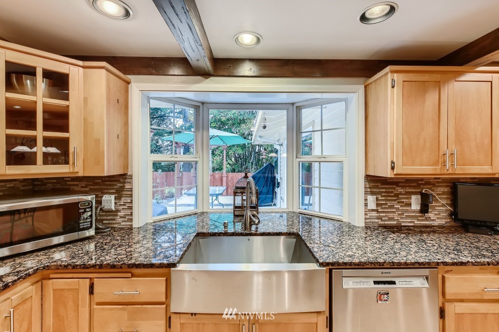 32219 22nd Avenue Southwest Federal Way, WA 98023 - Photo 16 of 36 a kitchen with granite countertop a sink and a counter top space
