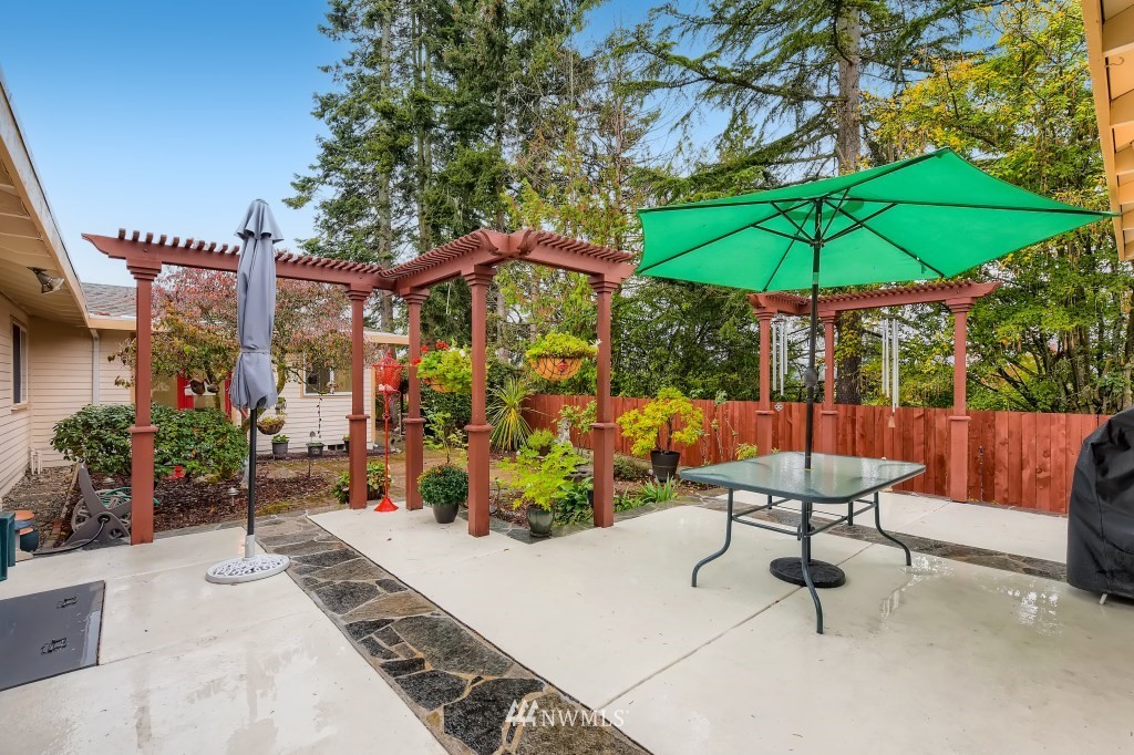 32219 22nd Avenue Southwest Federal Way, WA 98023 - Photo 21 of 36 an outdoor space with furniture and umbrella