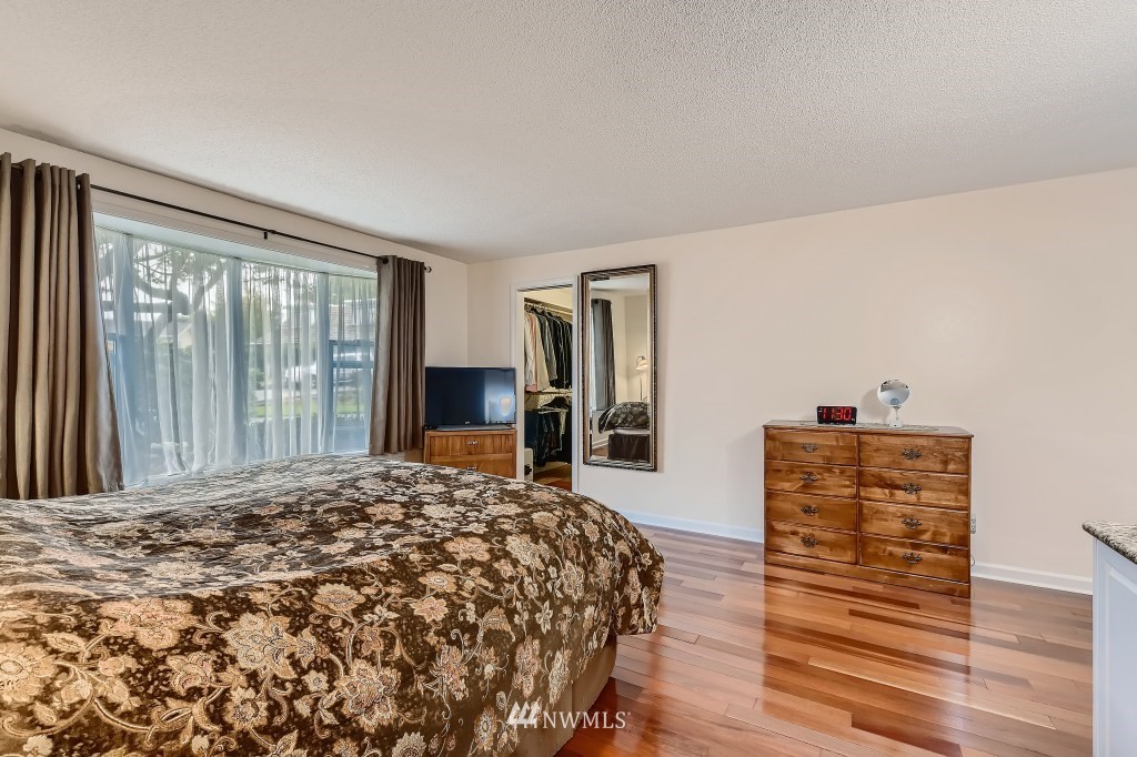 32219 22nd Avenue Southwest Federal Way, WA 98023 - Photo 23 of 36 a bed sitting in a spacious bedroom next to a window and dresser