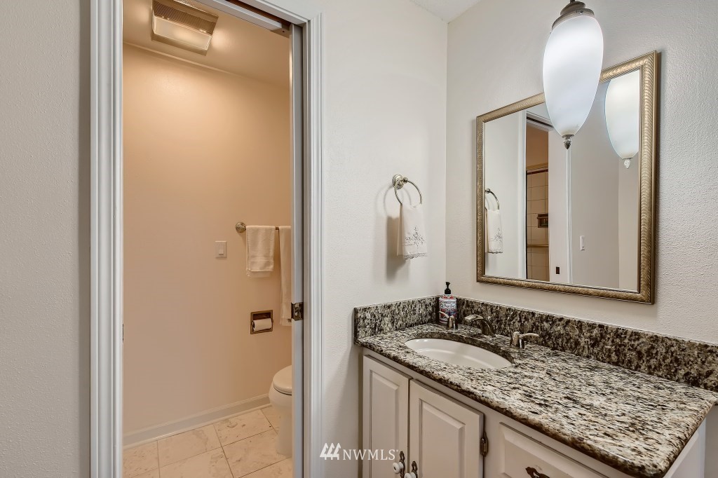 32219 22nd Avenue Southwest Federal Way, WA 98023 - Photo 26 of 36 a bathroom with a granite countertop sink and a mirror