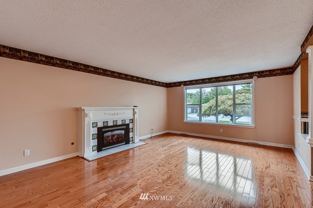 32219 22nd Avenue Southwest Federal Way, WA 98023 - Photo 6 of 36 a view of an empty room with a window and wooden floor