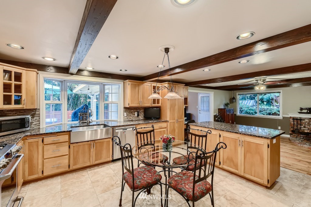 32219 22nd Avenue Southwest Federal Way, WA 98023 - Photo 10 of 36 a large kitchen with a table and chairs in it