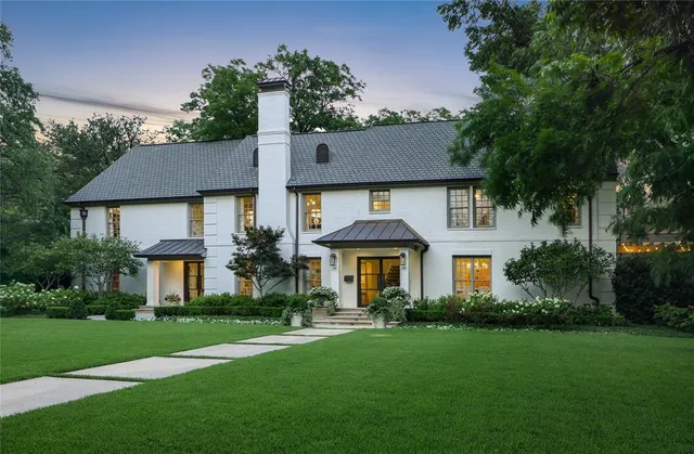 an aerial view of a house with a yard and outdoor seating