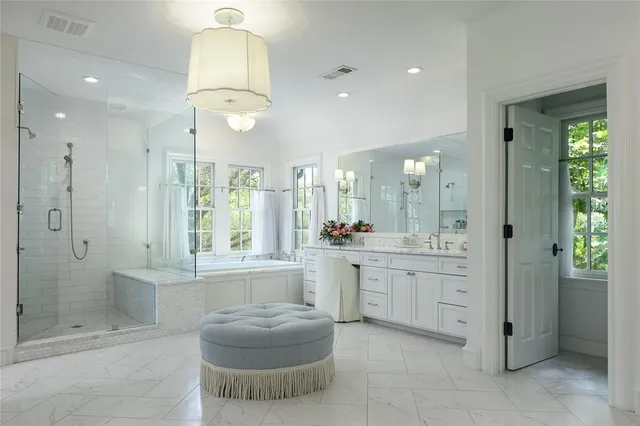 a bedroom with a large bed and a chandelier