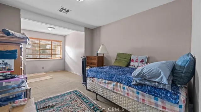 a living room with a bed furniture and a window