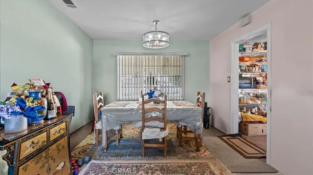 a view of a dining room with furniture and window