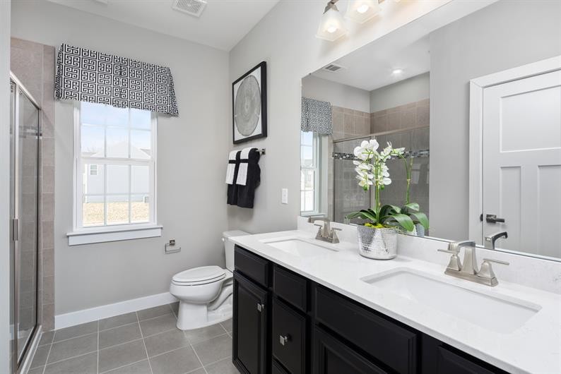 1030 Oglethorpe Drive Franklin, TN 37064 - Photo 11 of 17 a bathroom with a double vanity sink toilet and a mirror